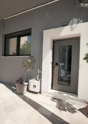 a front door of a house with two windows at Sia's Retreat 2 Modern Apt Athens Riviera in Athens