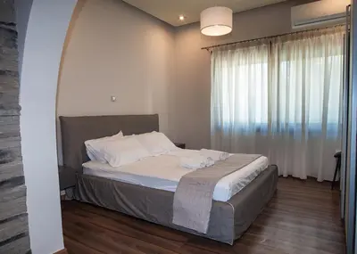 a bedroom with a bed and a large window at Sia's Retreat 2 Modern Apt Athens Riviera in Athens