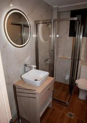 a bathroom with a sink and a shower at Sia's Retreat 2 Modern Apt Athens Riviera in Athens