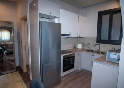 a kitchen with a stainless steel refrigerator and a sink at Sia's Retreat 2 Modern Apt Athens Riviera in Athens