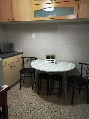 a table and four chairs in a kitchen at Unique 3 BDRM apartment, 5 min walk from Acropolis in Athens