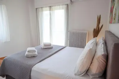 a bedroom with a bed with two towels on it at Modern Top Floor Apt, 5min to Acropolis & Plaka in Athens