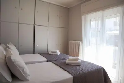 a bedroom with a bed with two towels on it at Modern Top Floor Apt, 5min to Acropolis & Plaka in Athens