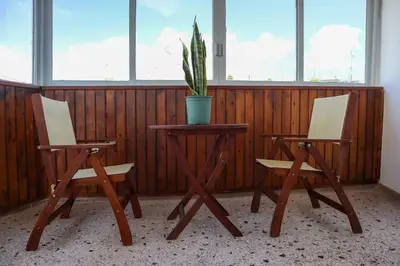 two chairs and a table with a potted plant on it at Modern Top Floor Apt, 5min to Acropolis & Plaka in Athens