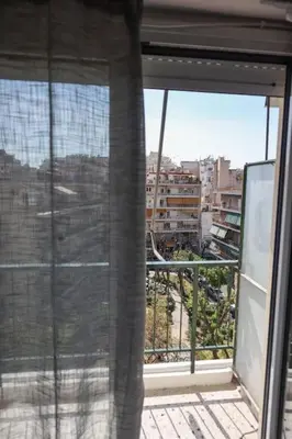 an open window with a view of a city at Modern Top Floor Apt, 5min to Acropolis & Plaka in Athens