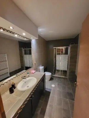 a bathroom with a sink and a toilet and a mirror at Villa Solaris in Sounio