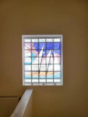 a stained glass window on a wall in a room at Villa Solaris in Sounio