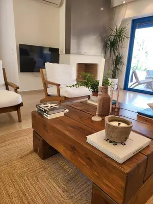 a living room with a wooden coffee table at Villa Solaris in Sounio