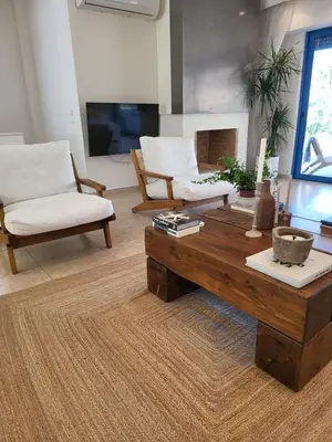 a living room with a coffee table and two chairs at Villa Solaris in Sounio