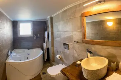 a bathroom with a tub and a toilet and a sink at Sarakin's Mansion Luxury Retreat in Athens
