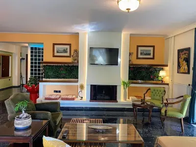 a living room filled with furniture and a fireplace at Sarakin's Mansion Luxury Retreat in Athens