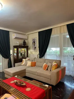 a living room with a couch and some windows at Sarakin's Mansion Luxury Retreat in Athens