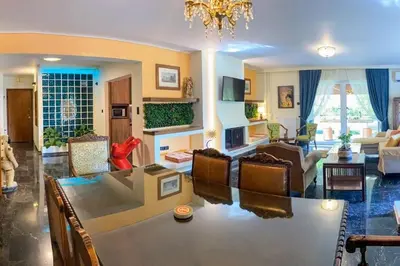 a living room with a table and a dining room at Sarakin's Mansion Luxury Retreat in Athens