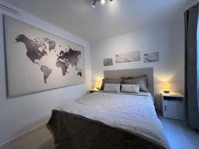 a bedroom with a bed with a map on the wall at Diegos cozy Athens Apartment Walk to Acropolis in Athens