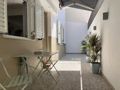 a hallway with a table and chairs in a building at Diegos cozy Athens Apartment Walk to Acropolis in Athens