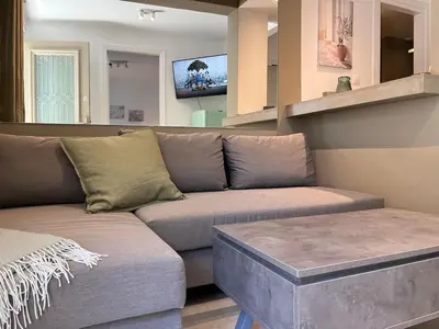a living room with a couch and a tv at Diegos cozy Athens Apartment Walk to Acropolis in Athens