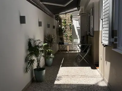 a hallway with potted plants on the side of a building at Diegos cozy Athens Apartment Walk to Acropolis in Athens
