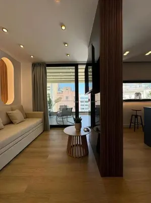 a living room with a couch and a table at BlueMotion - PortSuite 5B in Piraeus