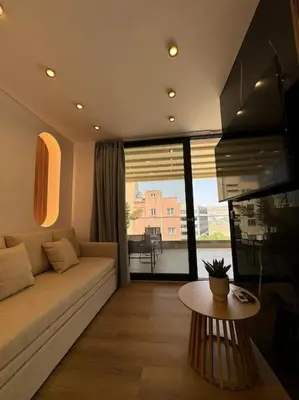 a living room with a couch and a table at BlueMotion - PortSuite 5B in Piraeus