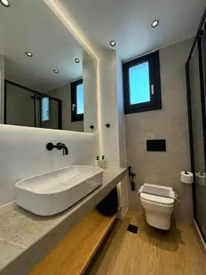 a bathroom with a white sink and a toilet at BlueMotion - PortSuite 5B in Piraeus