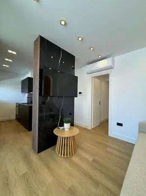 a living room with a tv and a table at BlueMotion - PortSuite 5B in Piraeus
