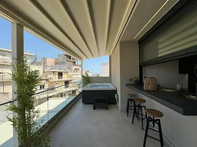 a balcony with a table and chairs on a building at BlueMotion - PortSuite 5B in Piraeus