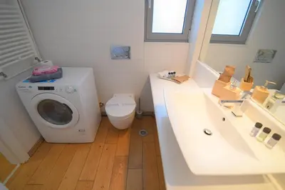 a bathroom with a washing machine and a sink at Acropolis Hill House in Athens