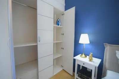 a bedroom with white shelves and a lamp on a night stand at Acropolis Hill House in Athens
