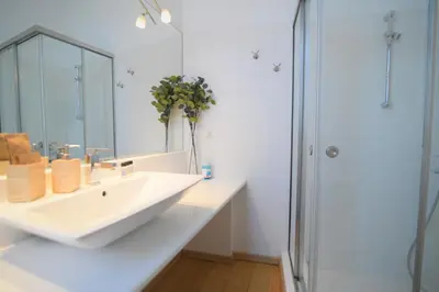 a white bathroom with a sink and a shower at Acropolis Hill House in Athens