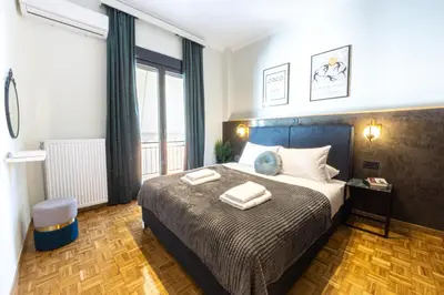 a bedroom with a bed with two towels on it at Polis luxury apartment 4 in Athens