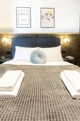 a bedroom with a large bed with two pillows at Polis luxury apartment 4 in Athens
