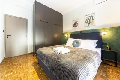 a bedroom with a bed with two towels on it at Polis luxury apartment 4 in Athens