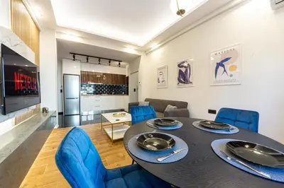 a dining room with a table and blue chairs at Polis luxury apartment 4 in Athens