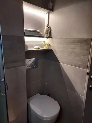 a small bathroom with a toilet and a mirror at Sunny studio near metro in Athens