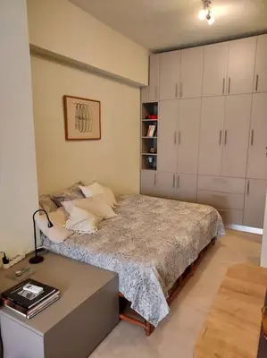 a bedroom with a bed and a desk in it at Sunny studio near metro in Athens