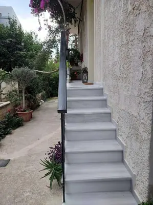 a set of white stairs leading up to a building at Sunny studio near metro in Athens
