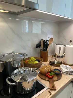 a kitchen counter with a pot and a bowl of vegetables at CK Athens Fine Stay Apartments - Lux & Modern - 2 min from Metro in Athens