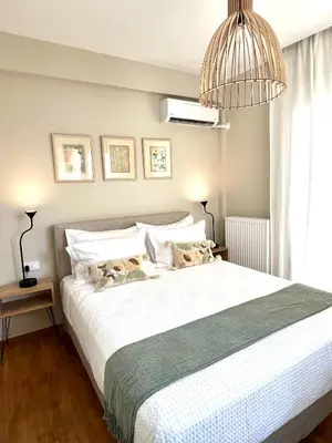 a bedroom with a large white bed with a pendant light at CK Athens Fine Stay Apartments - Lux & Modern - 2 min from Metro in Athens