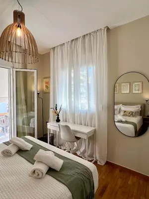 a bedroom with a bed and a desk and a mirror at CK Athens Fine Stay Apartments - Lux & Modern - 2 min from Metro in Athens
