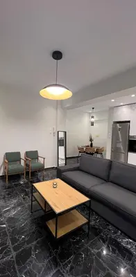 a living room with a couch and a table at CK Athens Fine Stay Apartments - Lux & Modern - 2 min from Metro in Athens