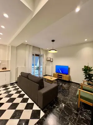 a living room with a couch and a tv at CK Athens Fine Stay Apartments - Lux & Modern - 2 min from Metro in Athens