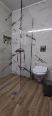 a bathroom with a toilet and a sink at Stone Apartment Close to the Airport in Spáta