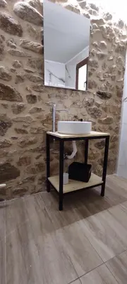 a bathroom with a sink and a mirror at Stone Apartment Close to the Airport in Spáta