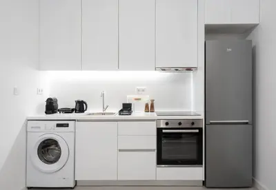 a white kitchen with a washing machine and a washer at LIV - Comfortable & Stylish Escape in Pagrati in Athens