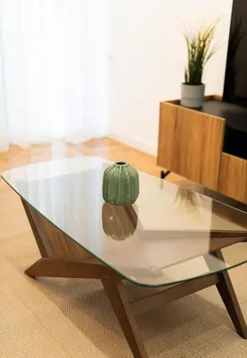 a green cap sitting on top of a glass coffee table at LIV - Comfortable & Stylish Escape in Pagrati in Athens