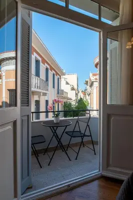 a sliding glass door leading to a balcony with a table at 1900's Athens Residence in Athens
