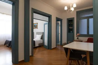a room with a room with a bed and a table at 1900's Athens Residence in Athens