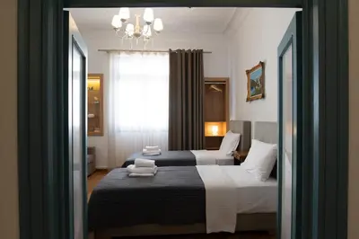 a bedroom with two beds and a window at 1900's Athens Residence in Athens