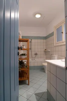 a bathroom with a tub and a sink and a toilet at 1900's Athens Residence in Athens