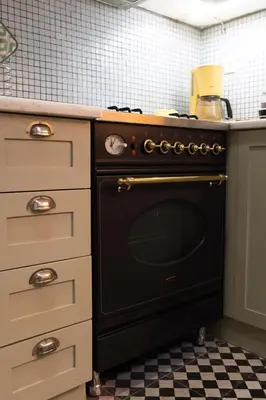 a kitchen with a black oven in a kitchen at 1900's Athens Residence in Athens